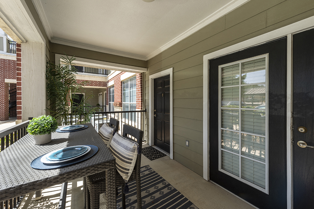 a dining room with a table and chairs on a balcony