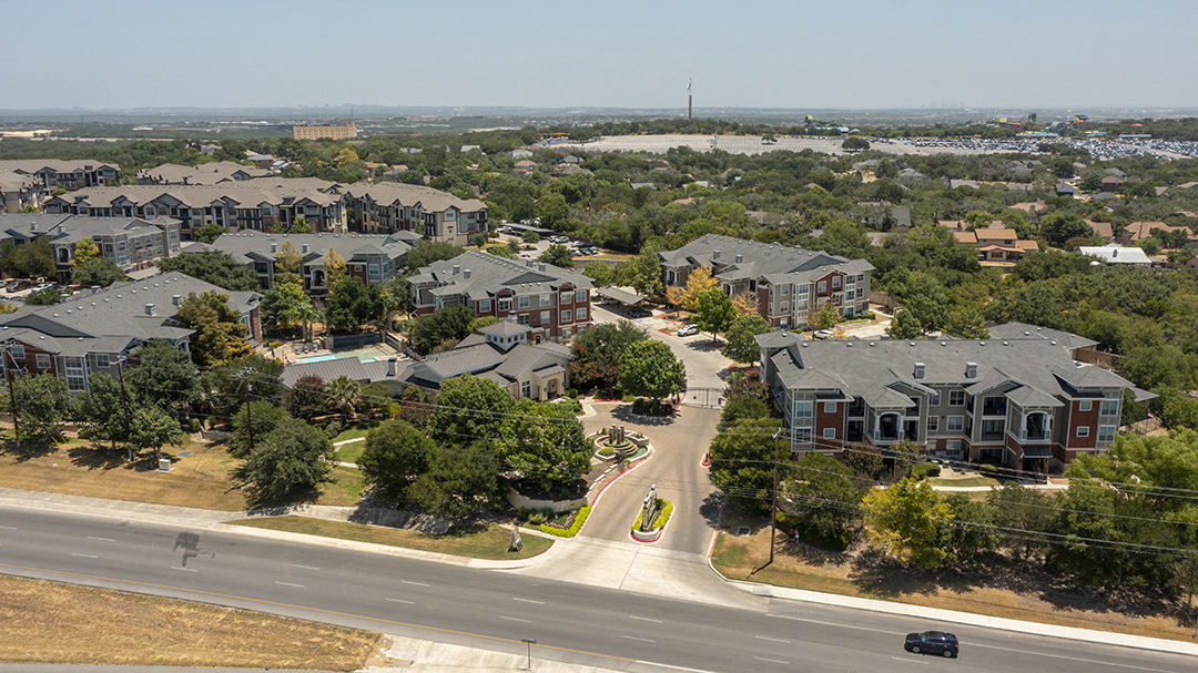 an aerial view of a neighborhood with houses and a road