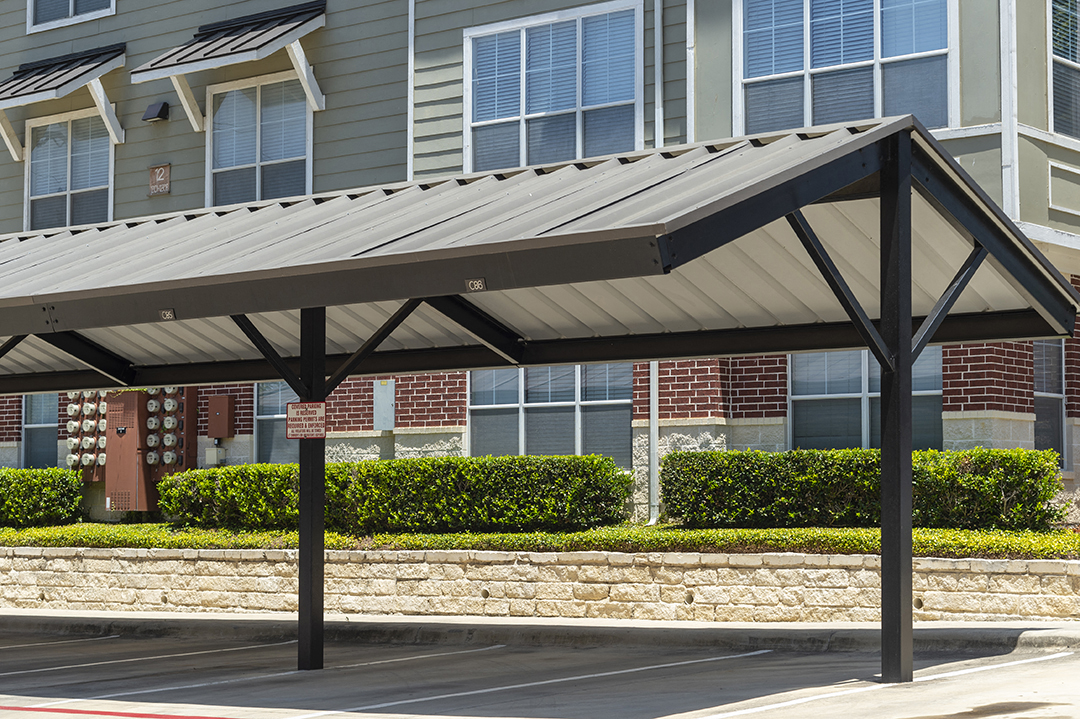 a patio with awning in front of a building