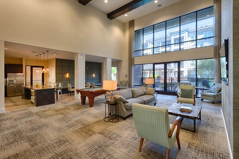 A spacious living room with a large window and a view of the city.