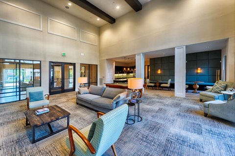 A living room with a grey couch and a blue chair.