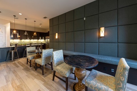 A modern dining room with a wooden table and chairs.