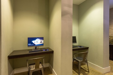 A computer is on a desk in a room.