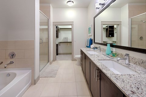 A bathroom with a white tub and a sink with a counter.