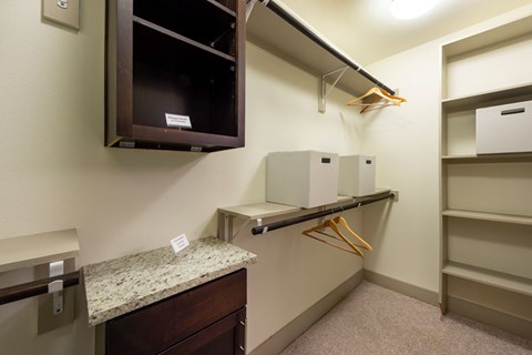 A room with a marble counter and a brown cabinet.