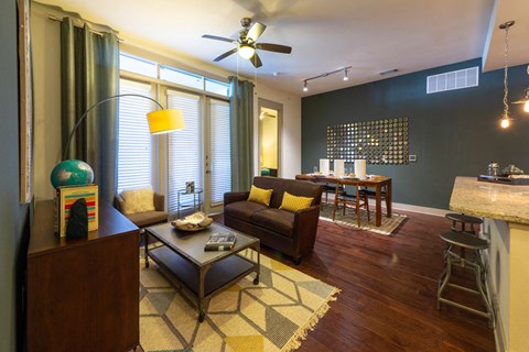 A living room with a brown couch and a coffee table.