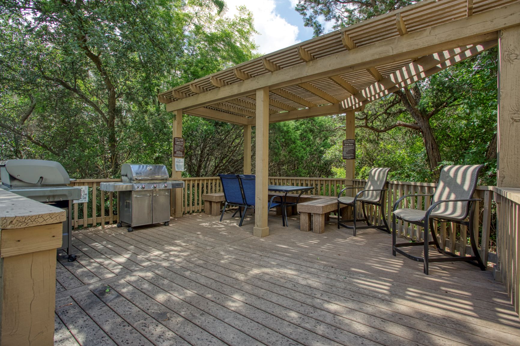 a covered patio with a pergola and a table with chairs