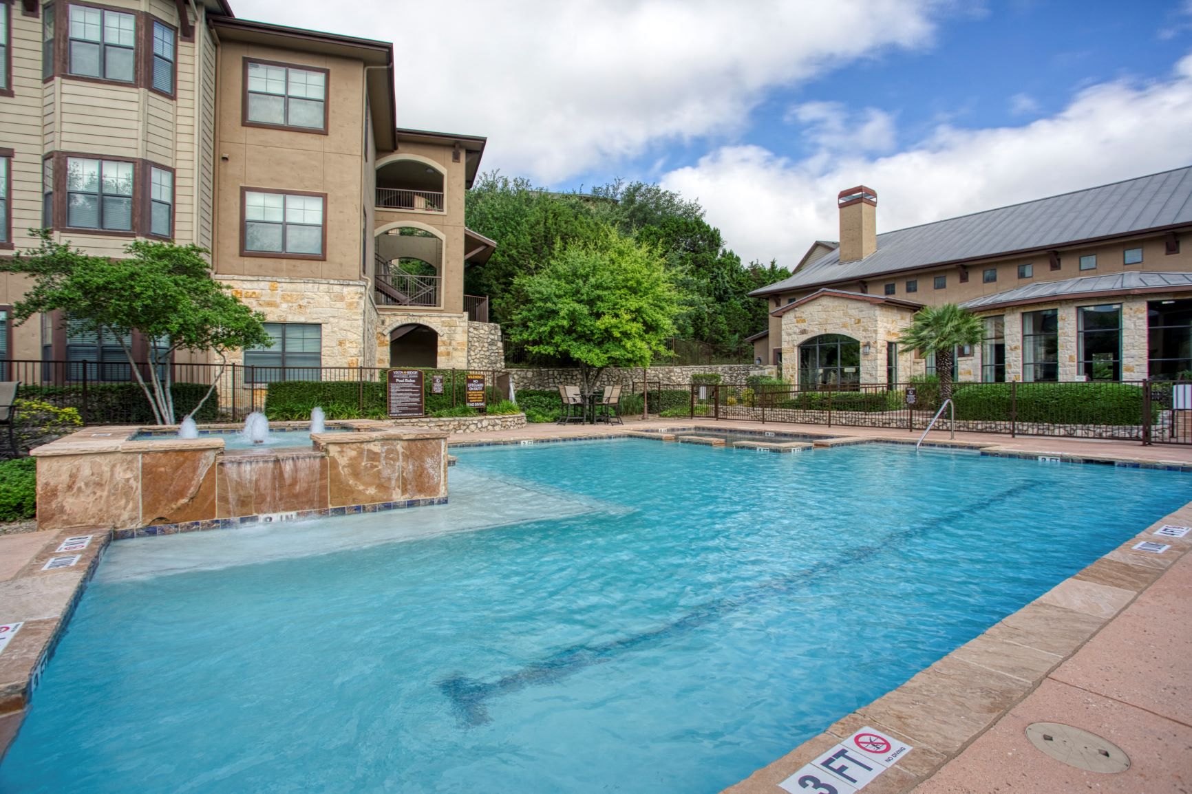 a swimming pool with a building in the background