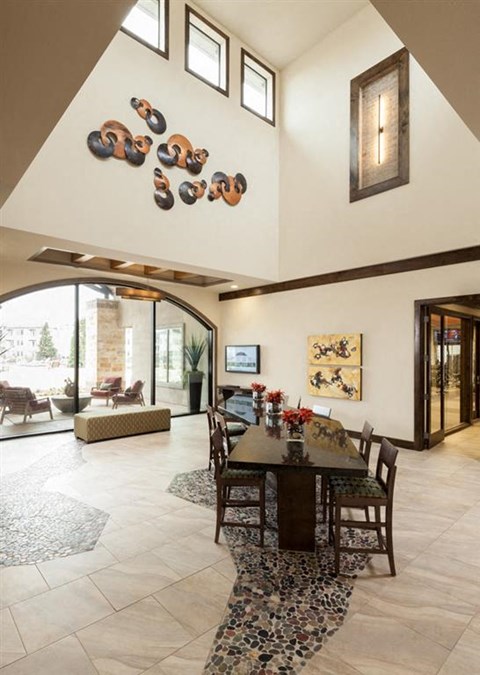 a dining room with a table and chairs