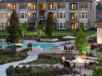 the back yard of an upscale hotel with a swimming pool and patio