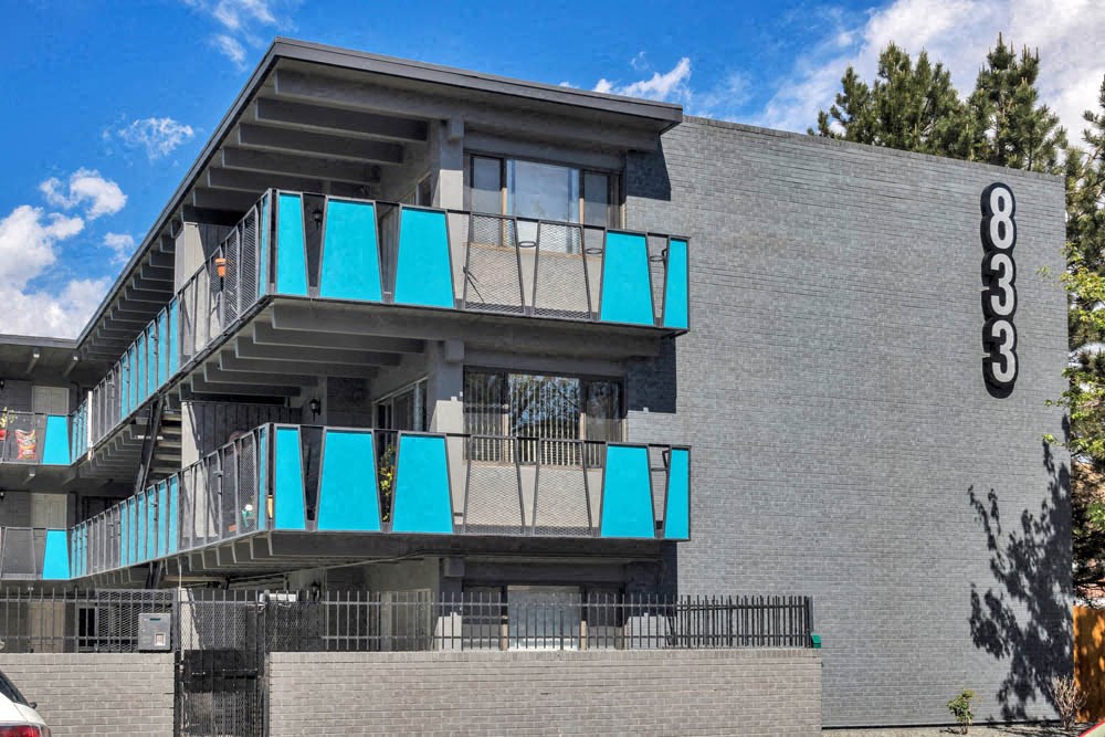 the side of a building with blue balconies