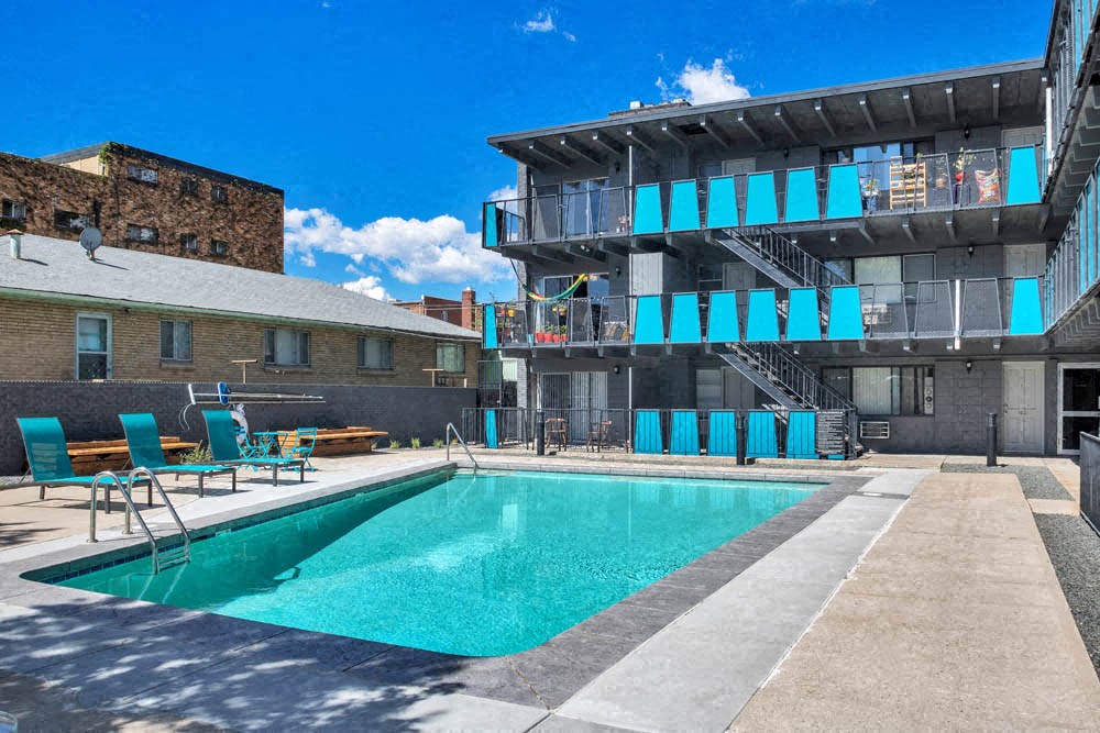 a swimming pool with a building in the background