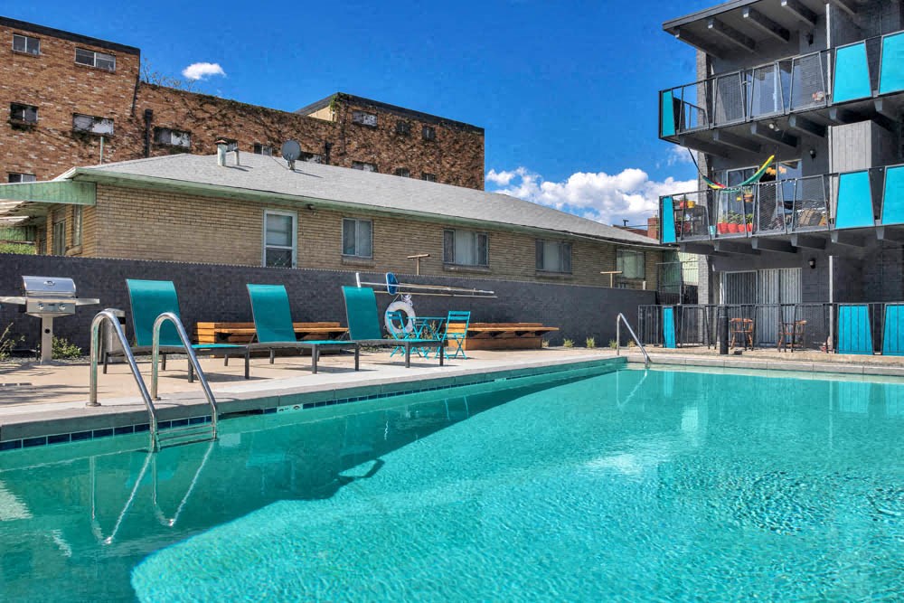 a swimming pool with a building in the background