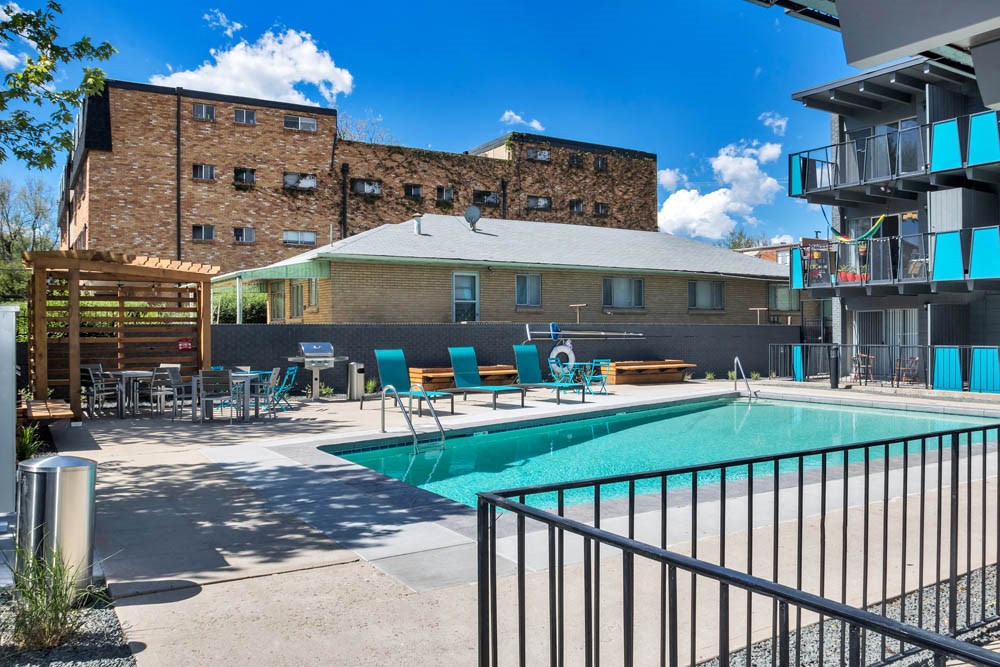 our apartments have a swimming pool and a building with a brick wall