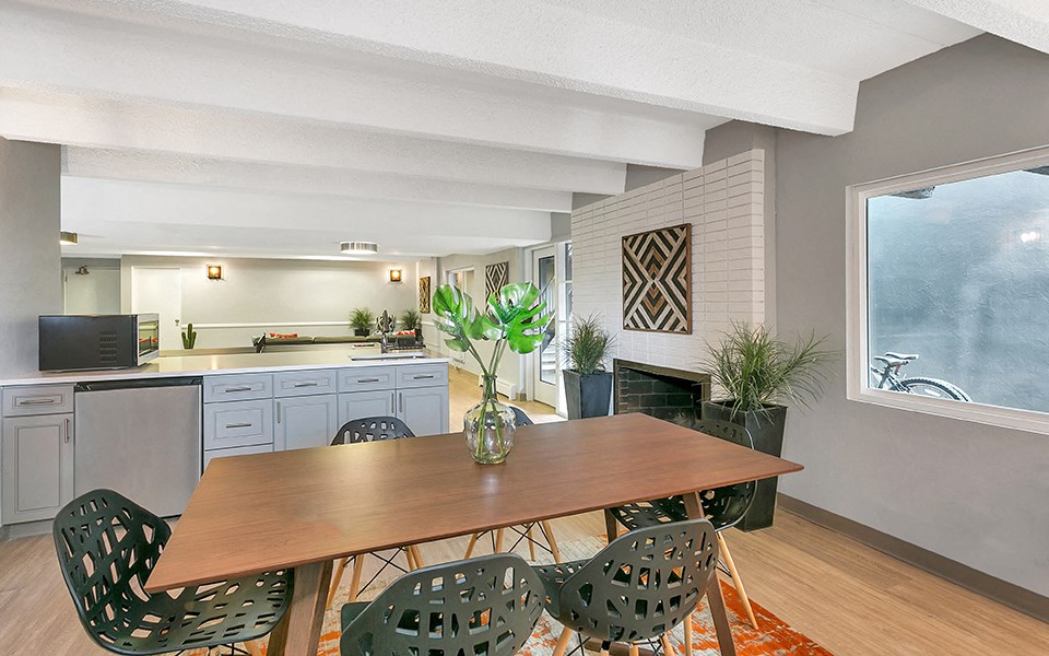 a kitchen and dining room with a table and chairs