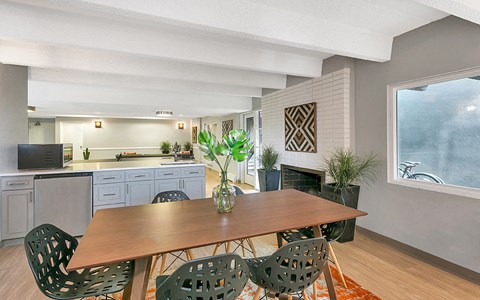 a kitchen and dining room with a table and chairs