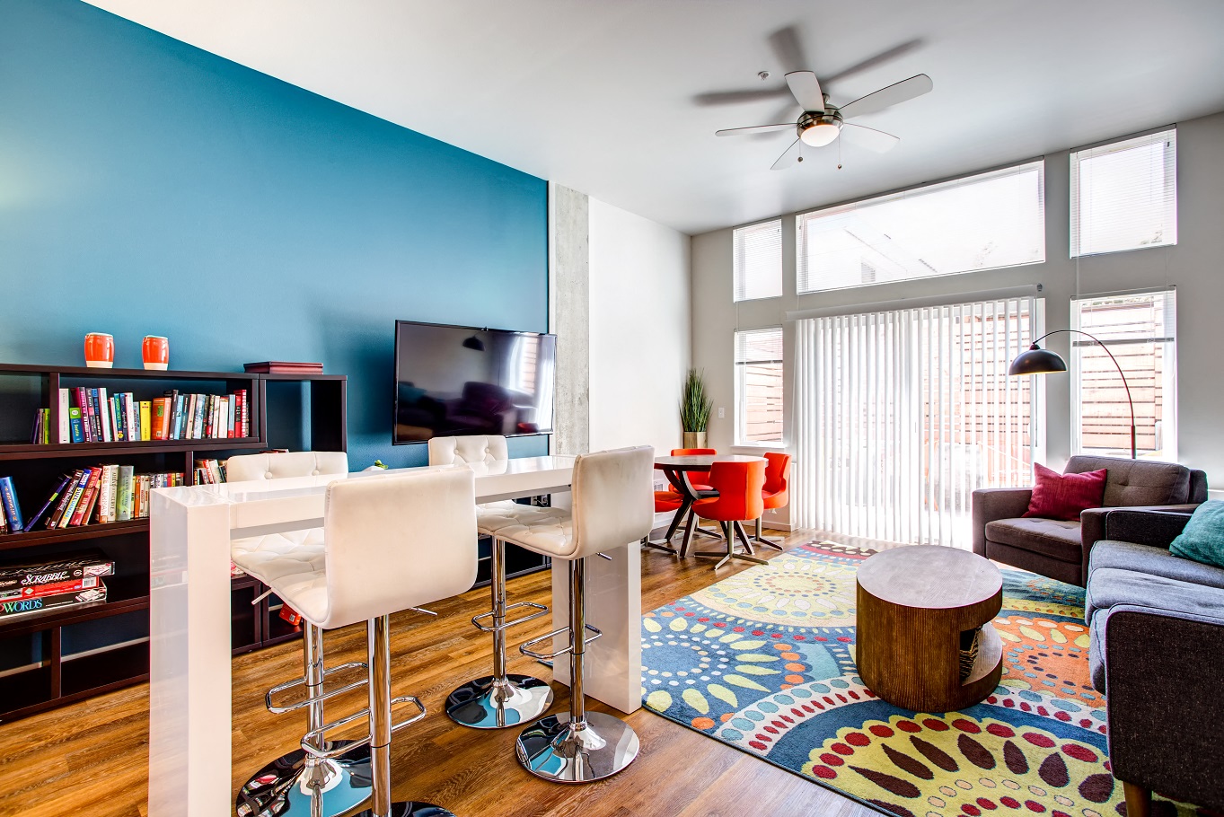 a living room with a blue wall and a table with chairs