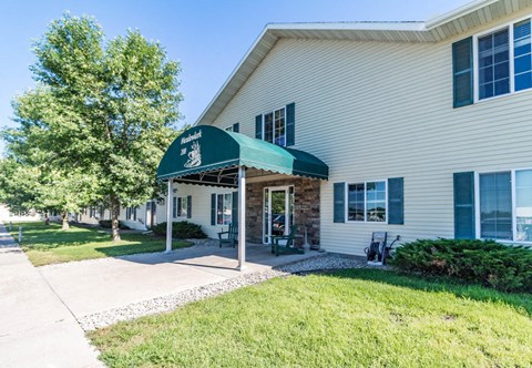 A white building with a green awning is the main focus of the image.