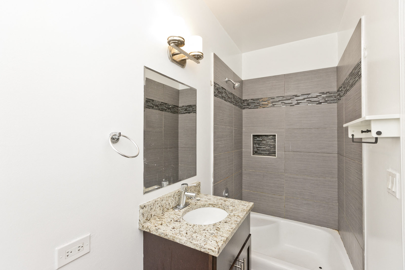 a bathroom with a sink and shower and a tub