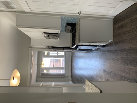 the view from the top of a staircase looking down into a room with a window