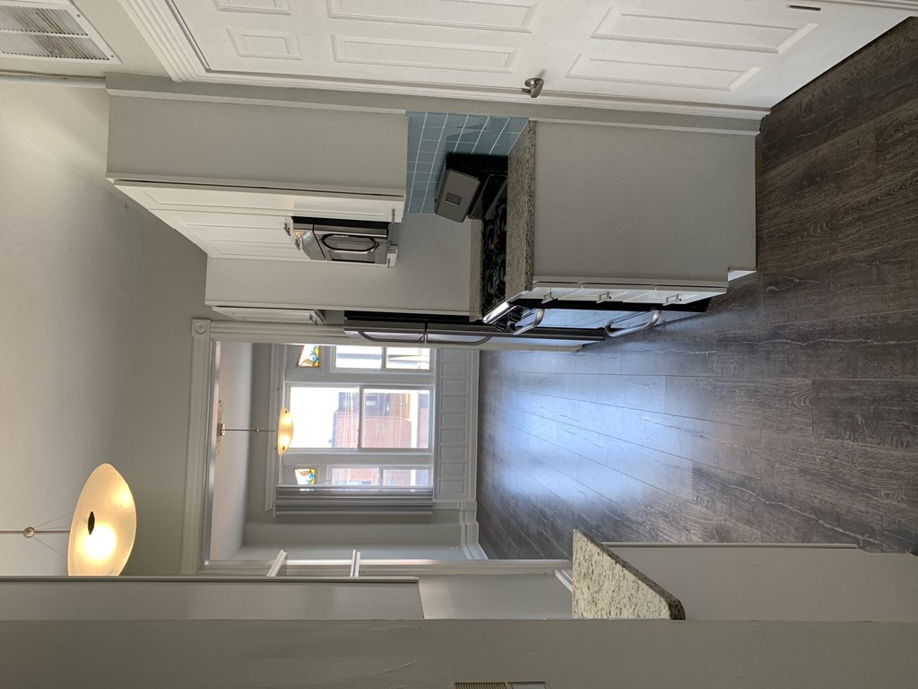 the view from the top of a staircase looking down into a room with a window