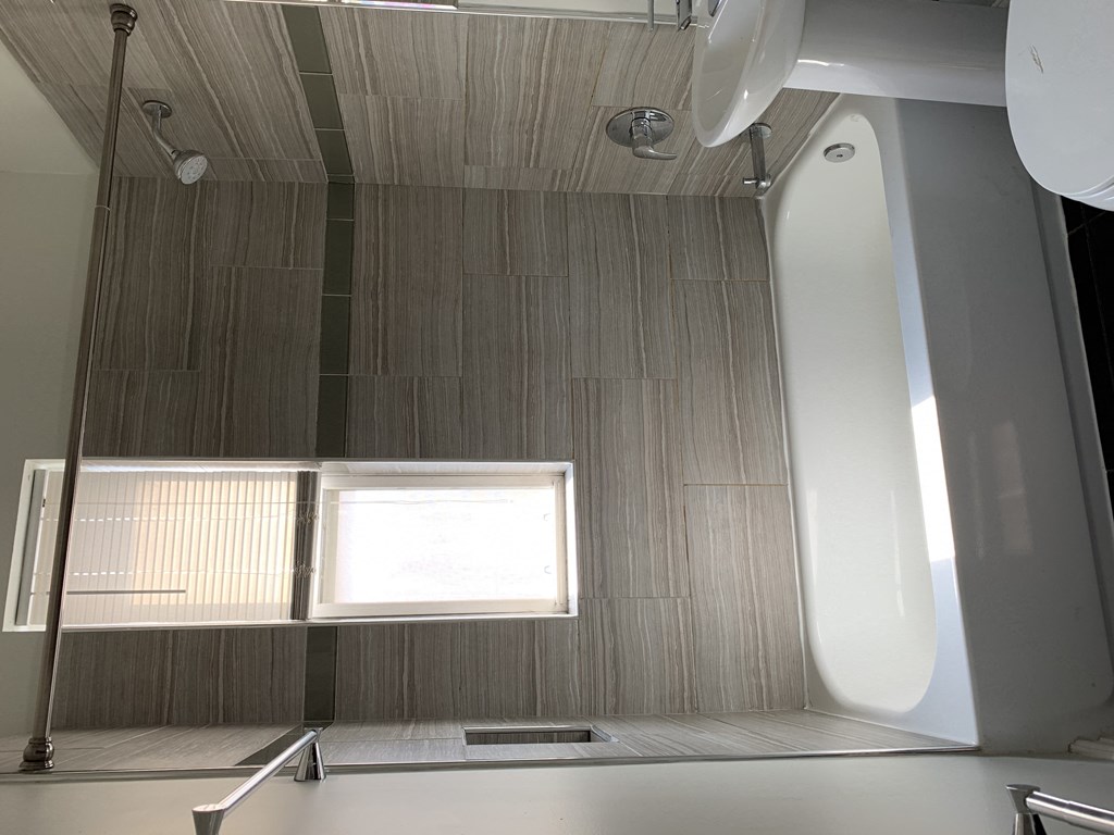 a small bathroom with a shower and a window