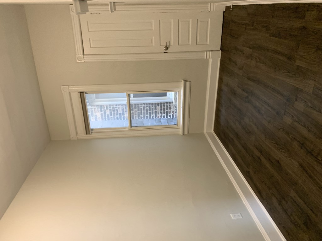 the view from the bottom of a room with a window