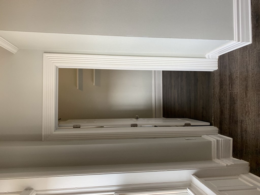 a large white bath tub with a mirror above it