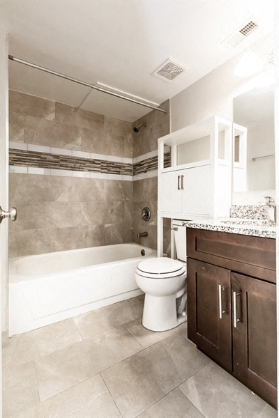 a bathroom with a toilet and a tub and a sink