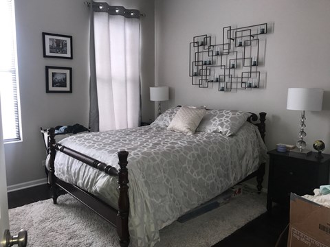 a bedroom with a bed and a wall art on the wall above it