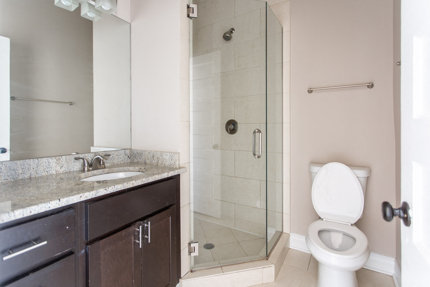 a bathroom with a toilet and a sink and a shower