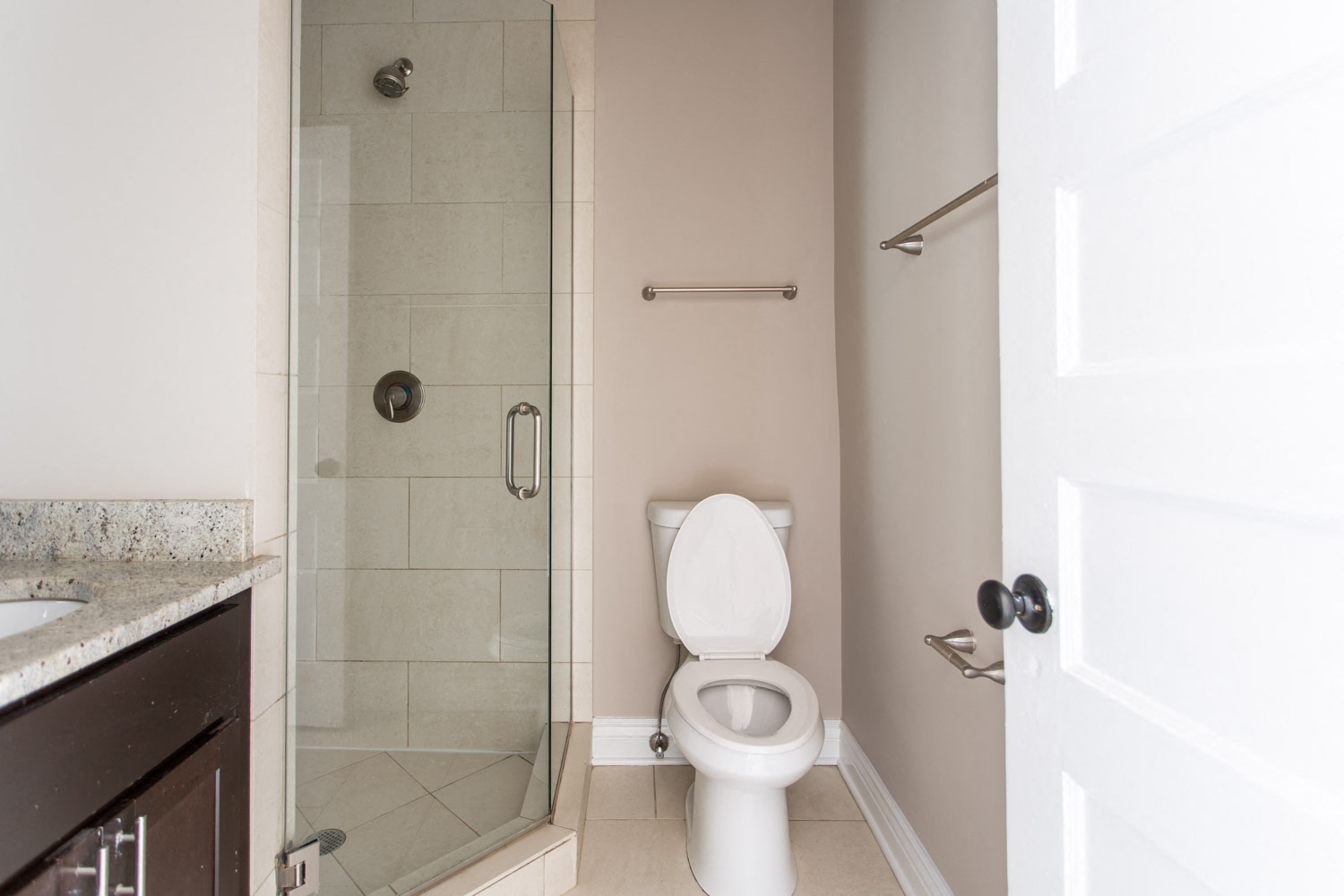 a bathroom with a toilet and a shower