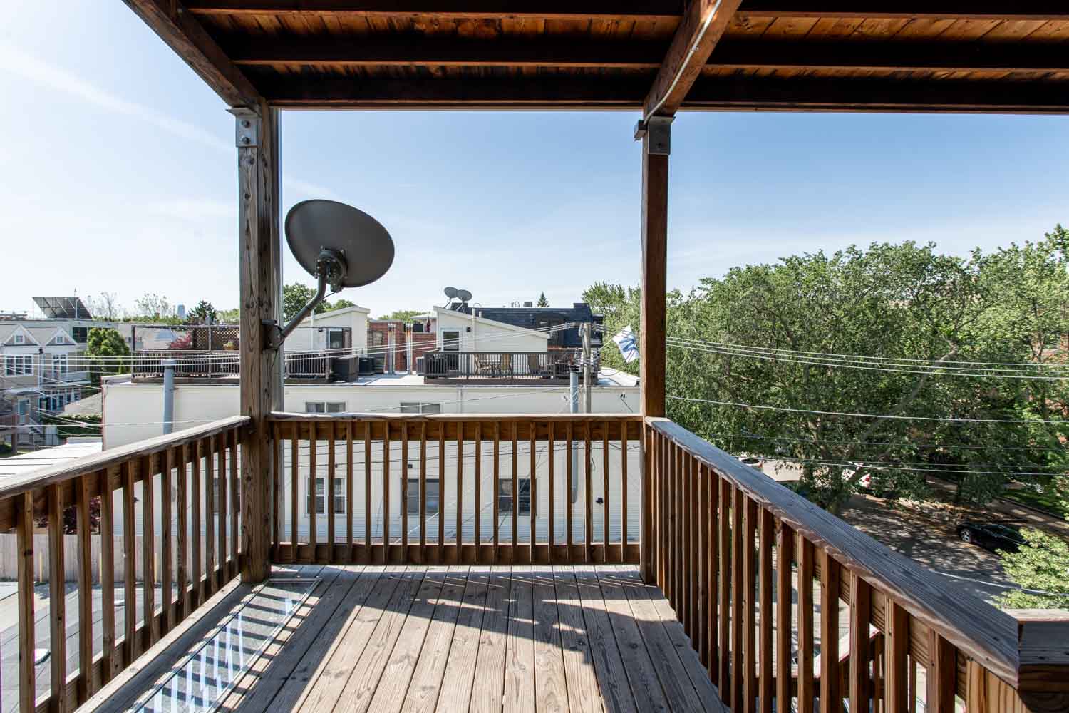 the deck has a view of the neighborhood and the city