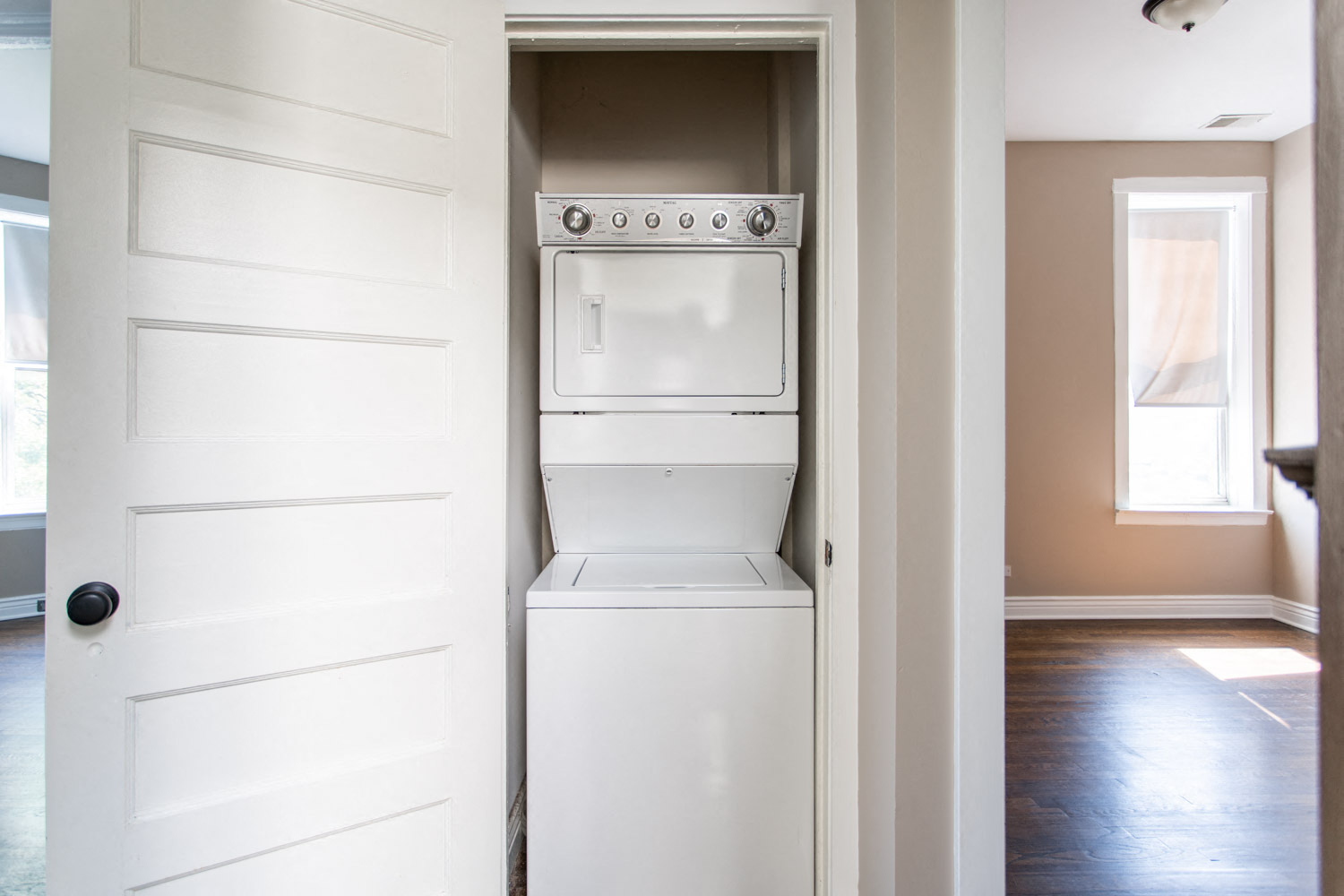 an empty laundry room with a washer and dryer