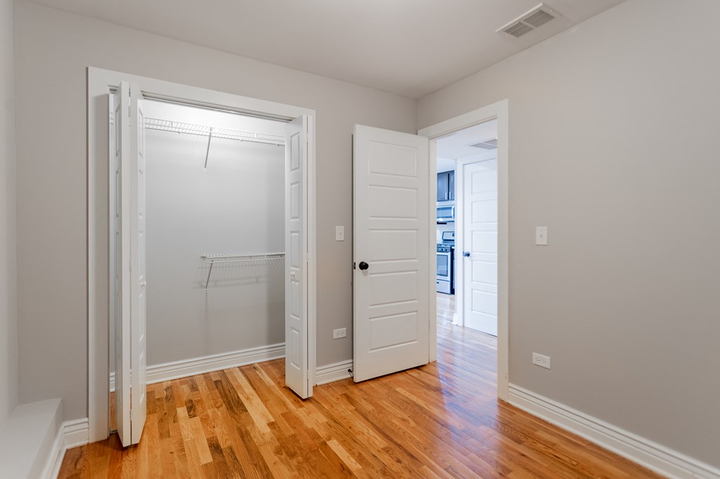 a bedroom with a closet and an open door