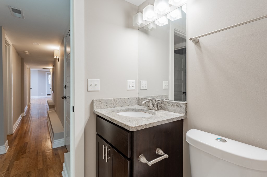 a bathroom with a mirror and a toilet and a sink