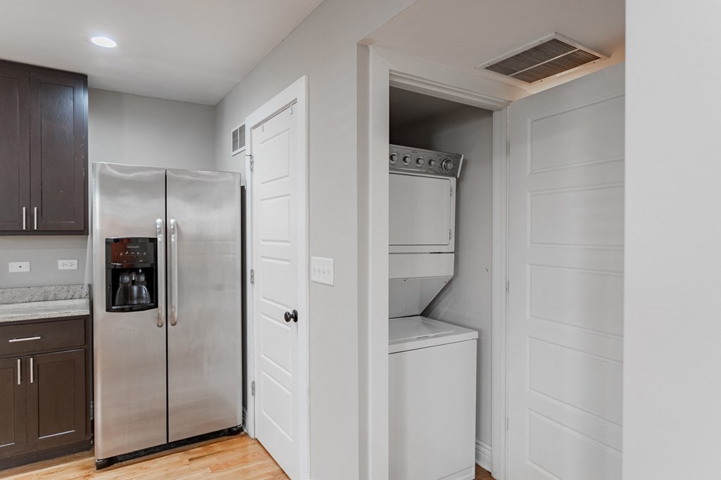 an empty kitchen with a refrigerator and a pantry