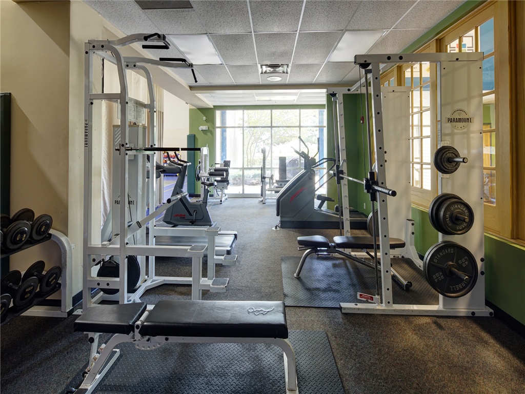 a fitness room with weights and other gym equipment