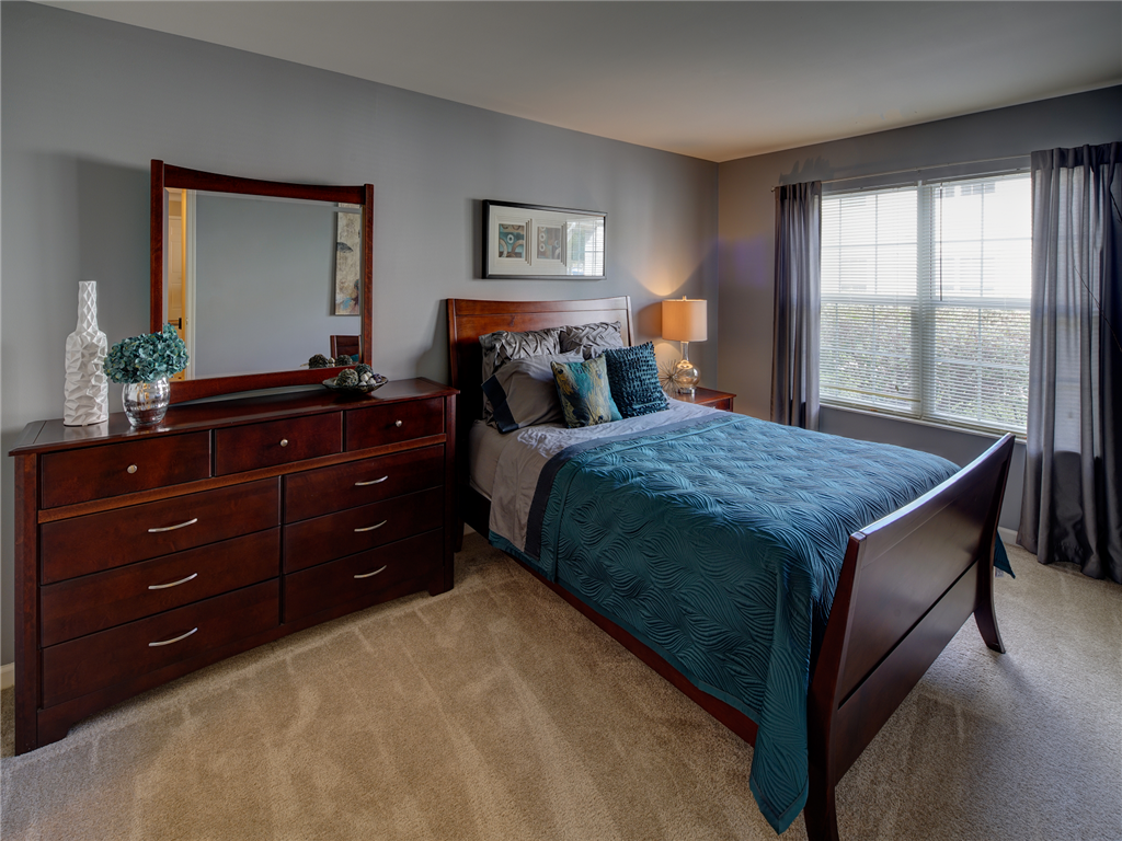 a bedroom with a bed and a dresser