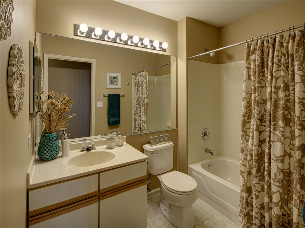 a bathroom with a shower toilet and sink and a mirror