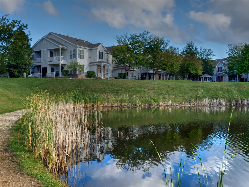 a small pond in front of a house