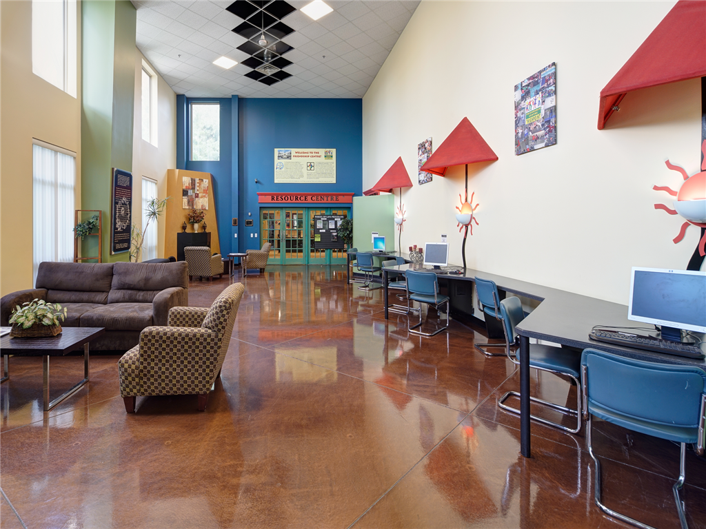 the lobby of a library with couches and tables and chairs