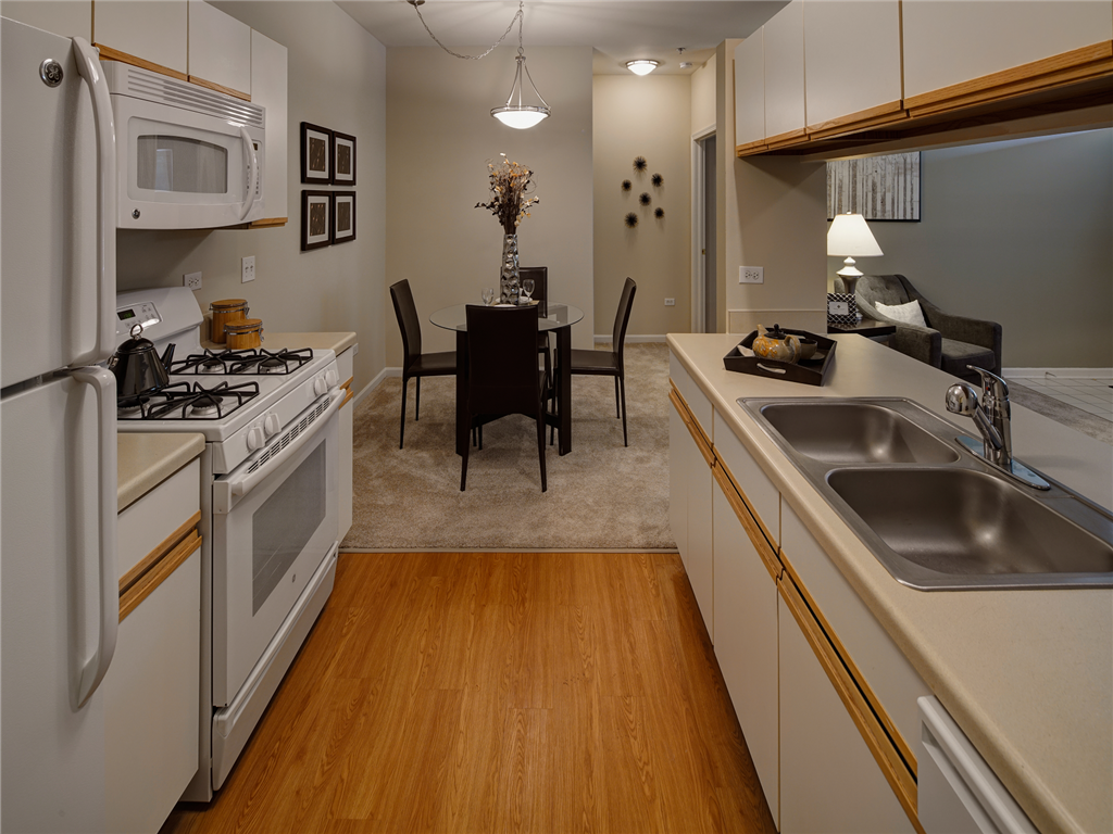 an open kitchen and dining room with a dining room table in the background