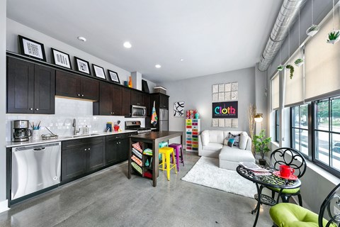 A modern kitchen with a dining table and chairs.