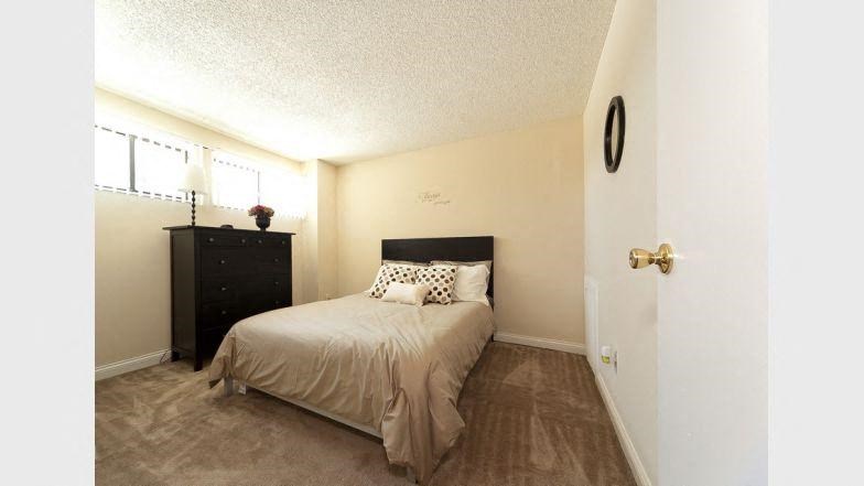 a small bedroom with a bed and a window