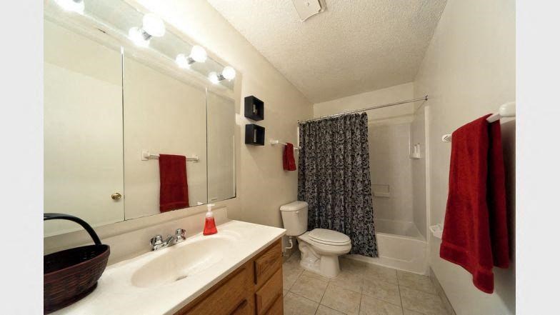 a bathroom with a toilet and a sink and a mirror