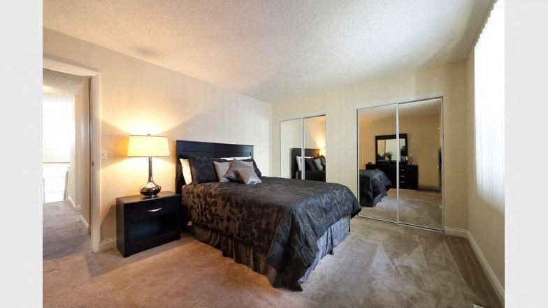 a bedroom with a large bed and a mirror