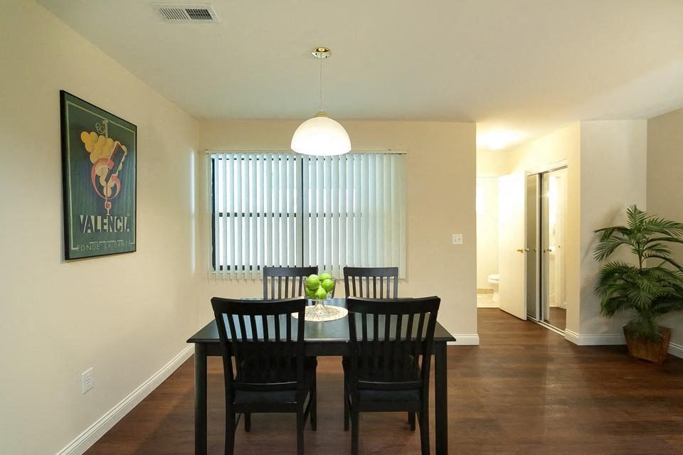 a dining room with a table and chairs