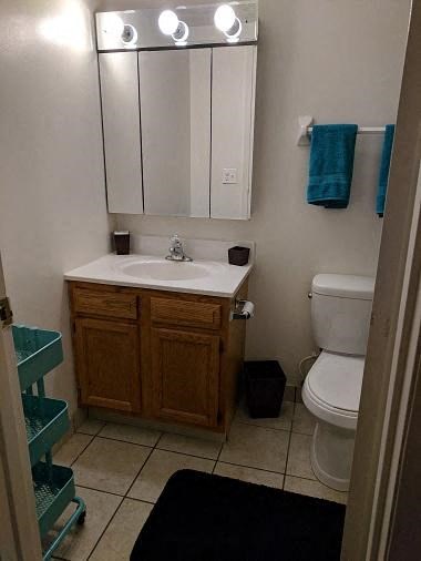 a bathroom with a sink toilet and a mirror