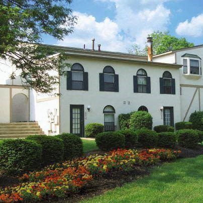 a white house with a garden in front of it